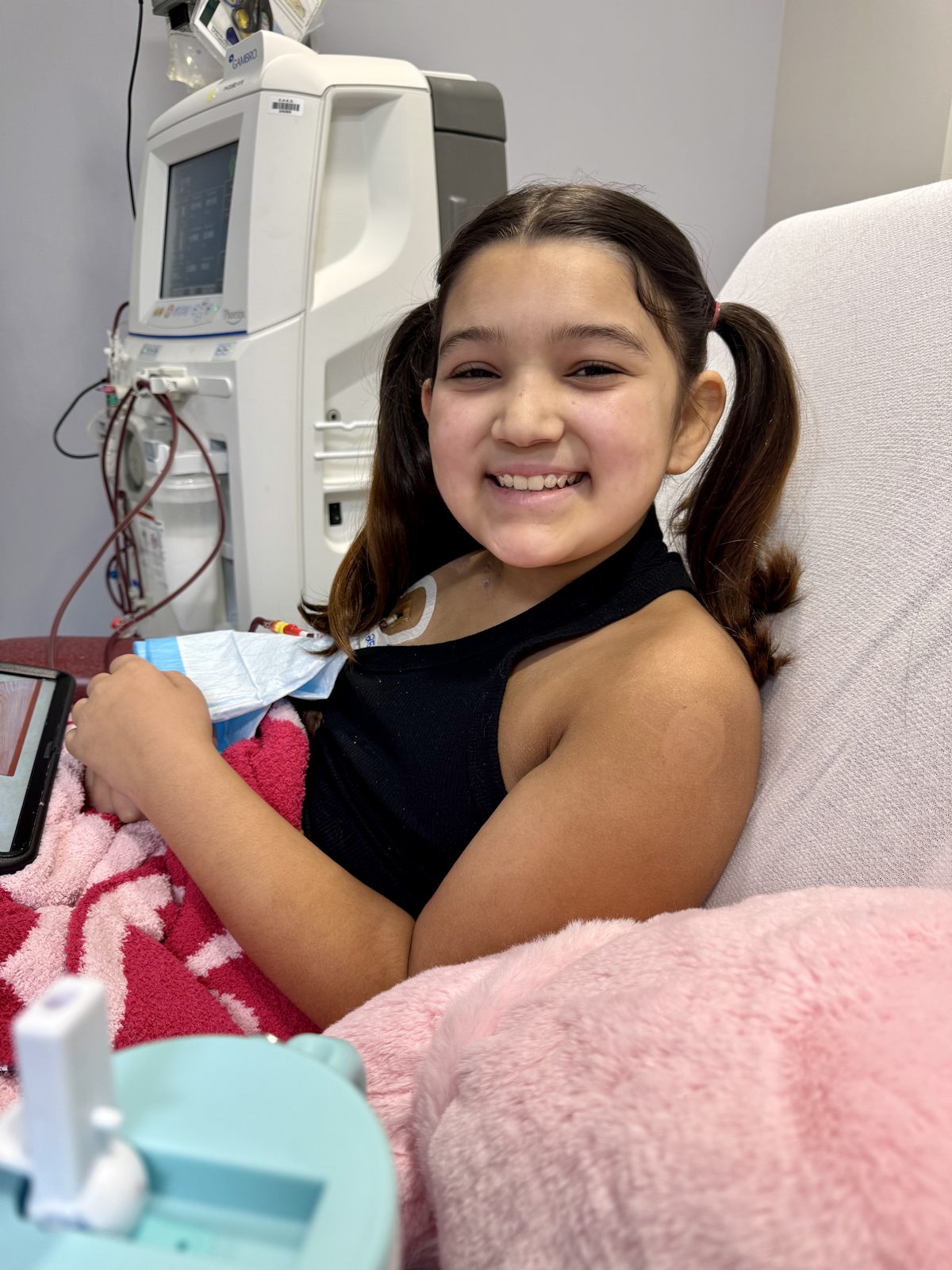 Sofia, 12, smiling during her dialysis treatment
